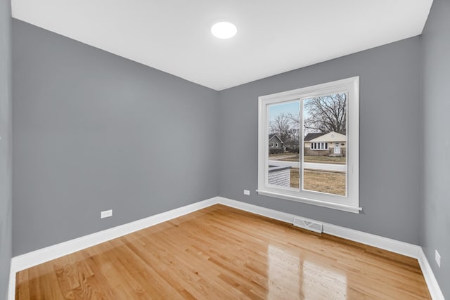 empty room with hardwood / wood-style flooring