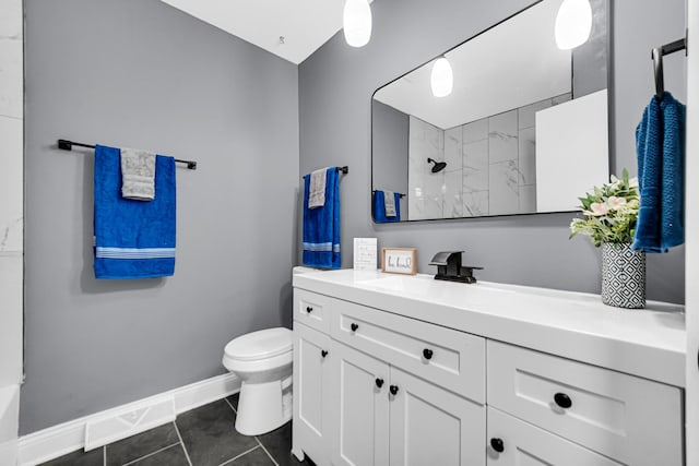 bathroom featuring tile patterned floors, vanity, toilet, and a shower