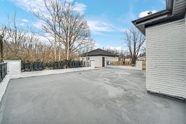 view of patio with an outbuilding and a garage