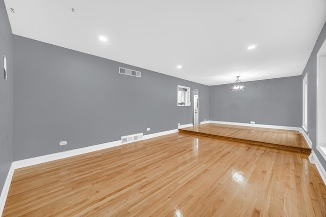 interior space featuring a chandelier and light hardwood / wood-style floors