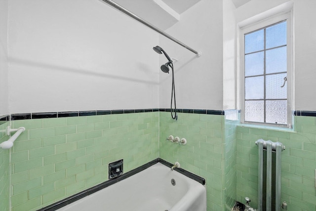 full bathroom featuring shower / bathing tub combination, wainscoting, tile walls, and radiator