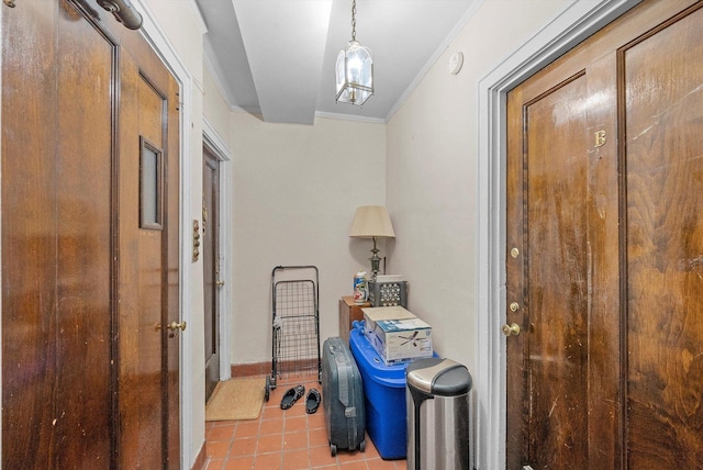 hallway featuring light tile patterned floors and ornamental molding