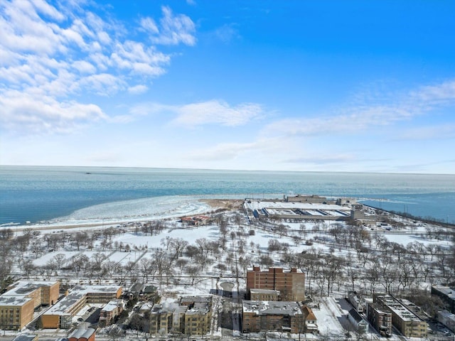 snowy aerial view with a water view