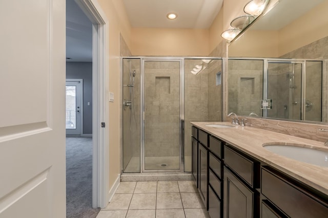 bathroom with vanity, an enclosed shower, and tile patterned floors