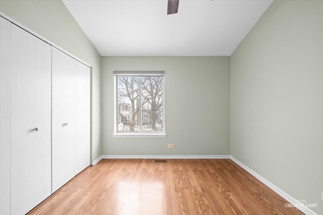 unfurnished bedroom featuring light hardwood / wood-style floors and a closet