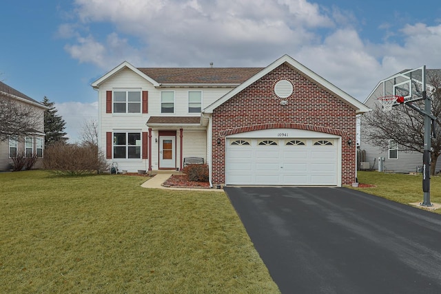 traditional home featuring driveway, brick siding, a garage, and a front yard