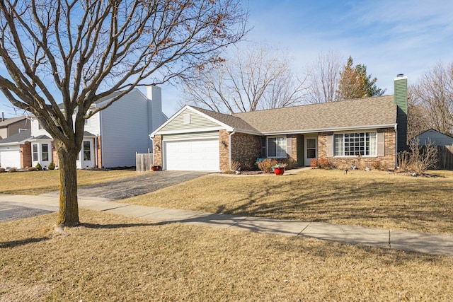 ranch-style home featuring a front lawn, an attached garage, brick siding, and driveway