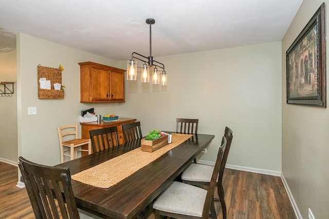 dining room with dark wood-style floors and baseboards