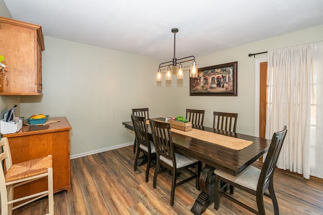 dining room with baseboards and dark wood-style flooring