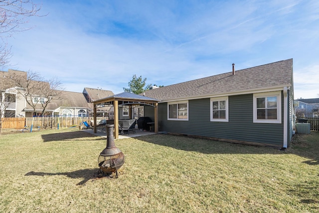 back of house with a lawn, fence, a gazebo, an outdoor fire pit, and a patio area