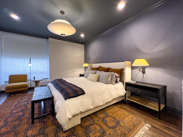 bedroom with dark hardwood / wood-style flooring and crown molding