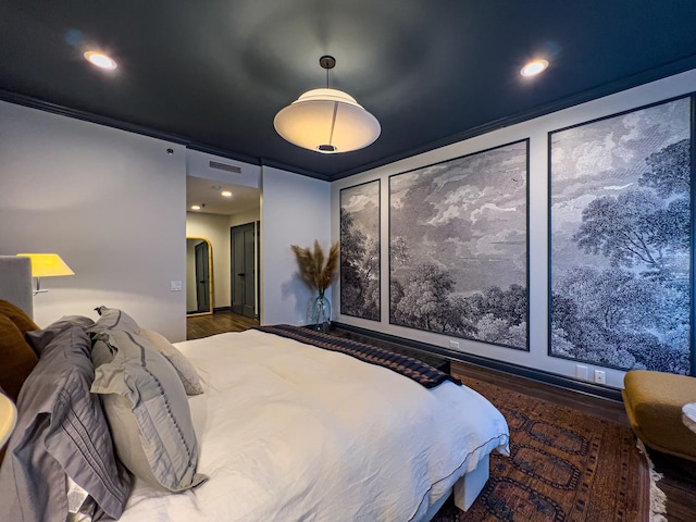 bedroom with dark hardwood / wood-style flooring