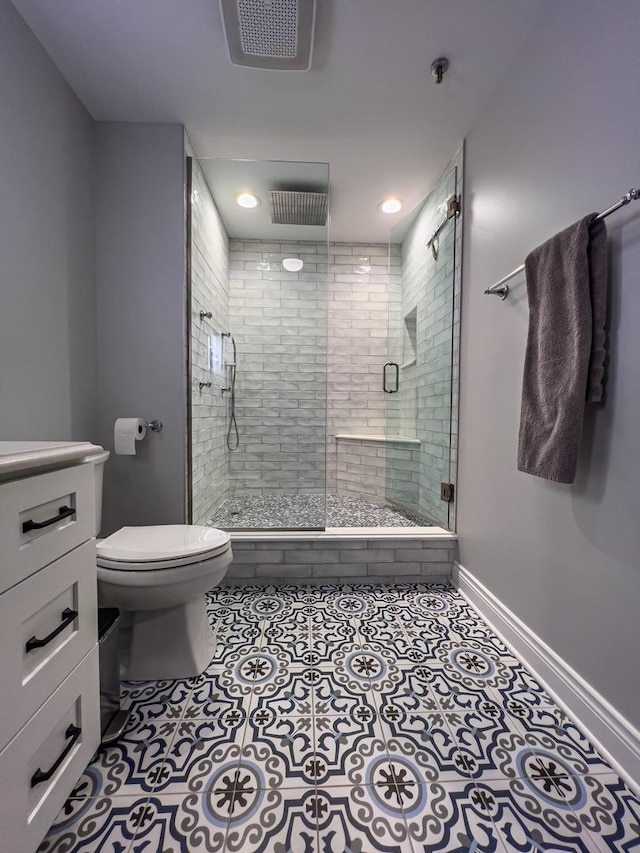 bathroom with vanity, toilet, an enclosed shower, and tile patterned flooring