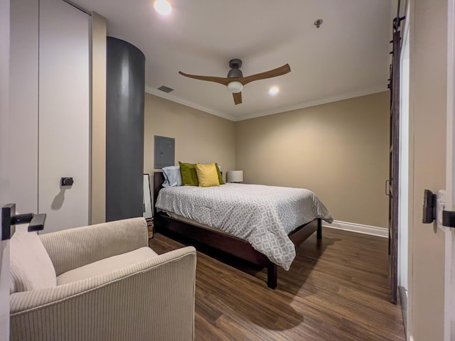 bedroom featuring ceiling fan, dark wood-type flooring, ornamental molding, and electric panel