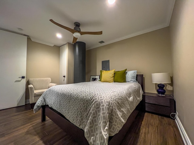 bedroom with crown molding, dark hardwood / wood-style floors, and ceiling fan