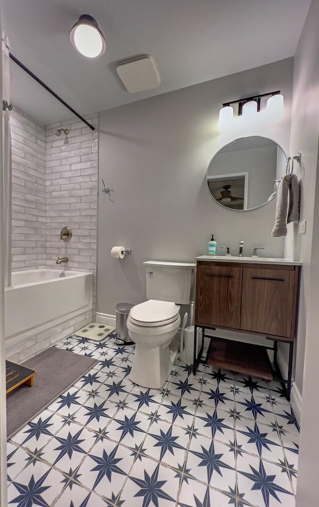 full bathroom with vanity, tiled shower / bath, and toilet