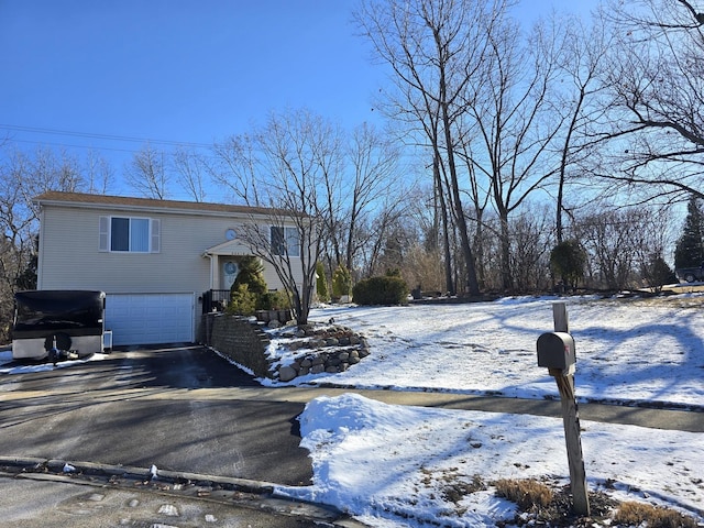 view of snow covered exterior featuring a garage