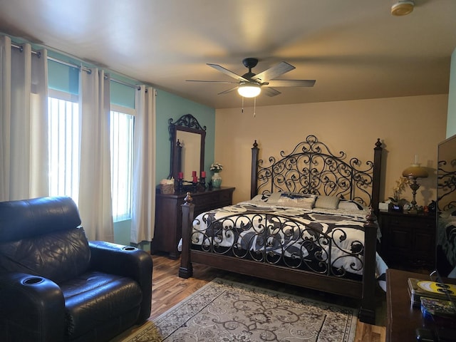 bedroom with hardwood / wood-style flooring and ceiling fan