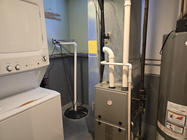 washroom featuring water heater and stacked washer / drying machine