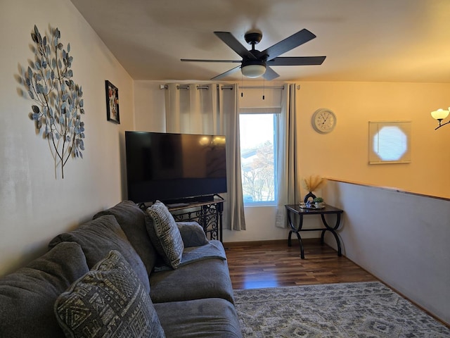 living room featuring ceiling fan and dark hardwood / wood-style floors