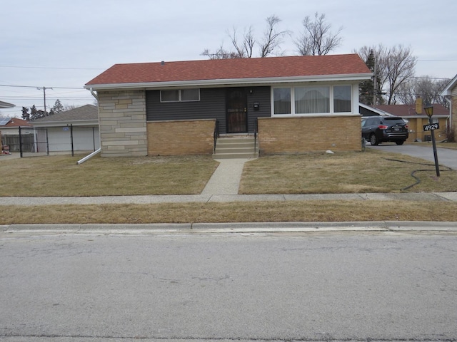 view of front of property with a garage and a front yard