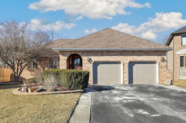 single story home featuring a garage and a front lawn