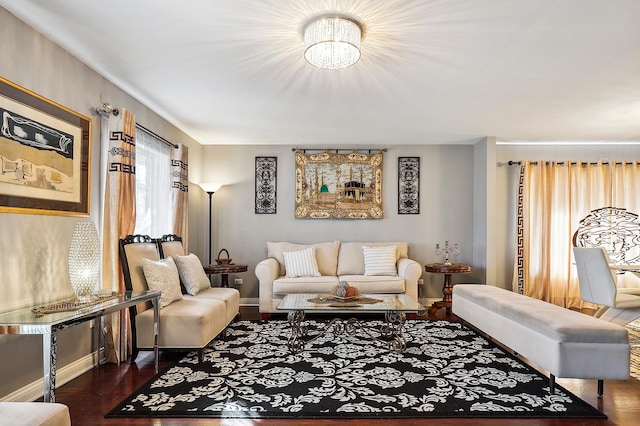 living room featuring dark wood-type flooring and a chandelier