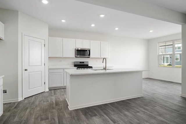 kitchen with appliances with stainless steel finishes, sink, and white cabinets