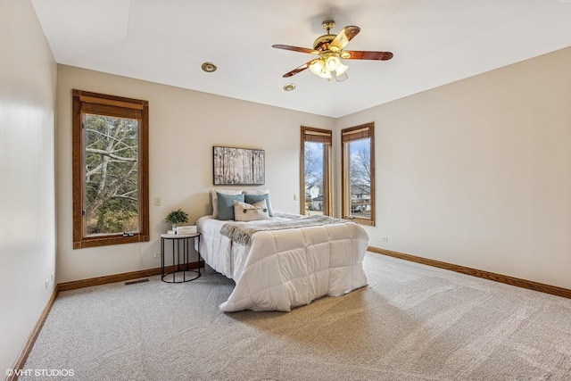 bedroom with carpet floors, a ceiling fan, and baseboards