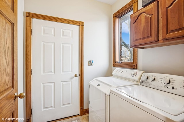 laundry room featuring cabinet space and separate washer and dryer