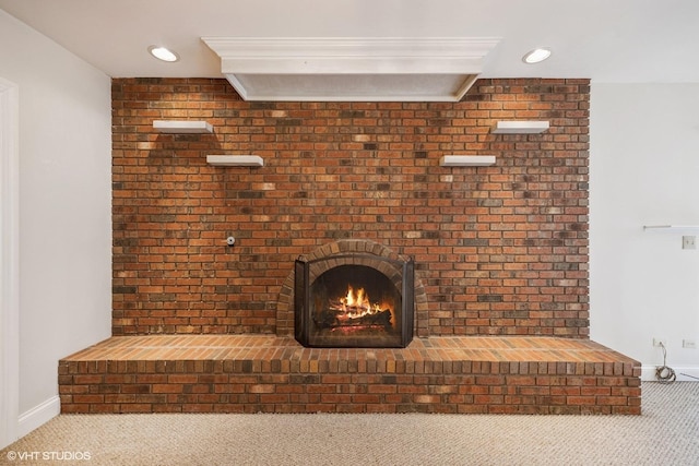 interior details featuring carpet floors, recessed lighting, a brick fireplace, and baseboards