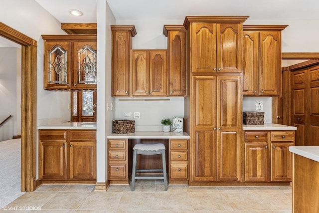 kitchen featuring brown cabinetry and light countertops