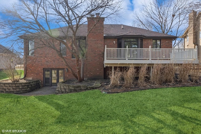 rear view of property featuring brick siding, a shingled roof, french doors, a lawn, and a chimney