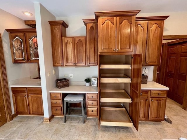 kitchen featuring light countertops and brown cabinetry