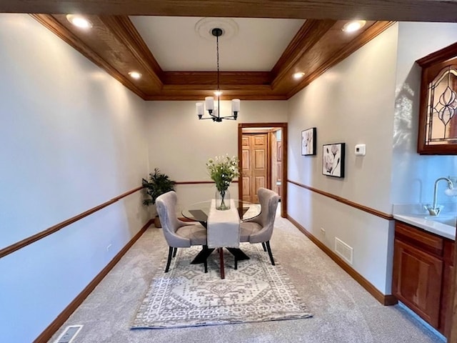 dining room with ornamental molding, visible vents, light carpet, and baseboards