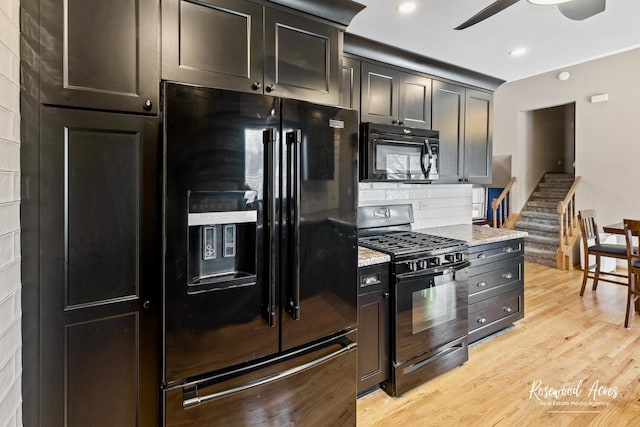 kitchen with light stone counters, light wood-style flooring, recessed lighting, ceiling fan, and black appliances