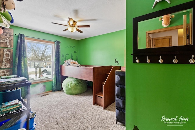 bedroom featuring visible vents, ceiling fan, a textured ceiling, and carpet