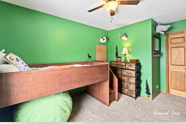 carpeted bedroom with a ceiling fan and baseboards