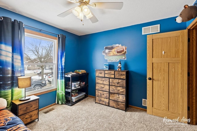 carpeted bedroom featuring visible vents, baseboards, and a ceiling fan