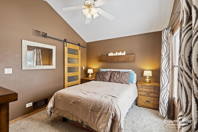 bedroom featuring a barn door, carpet flooring, visible vents, and lofted ceiling