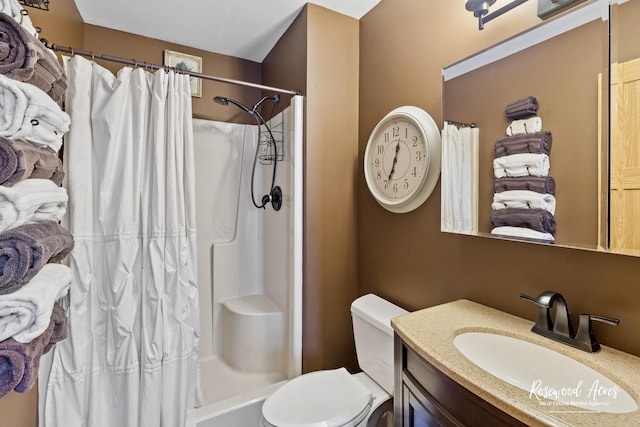 bathroom featuring vanity, toilet, and a shower with shower curtain