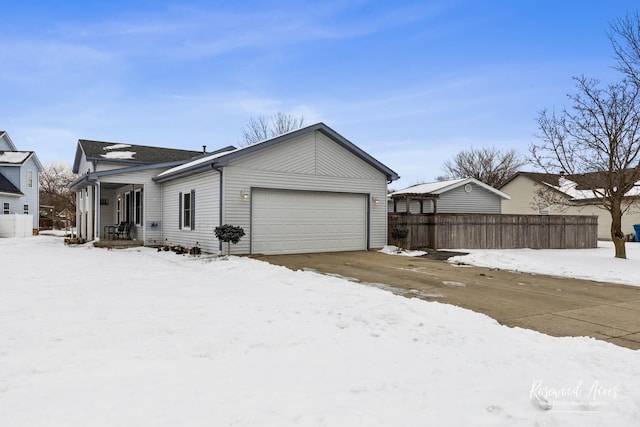 exterior space with an attached garage and fence