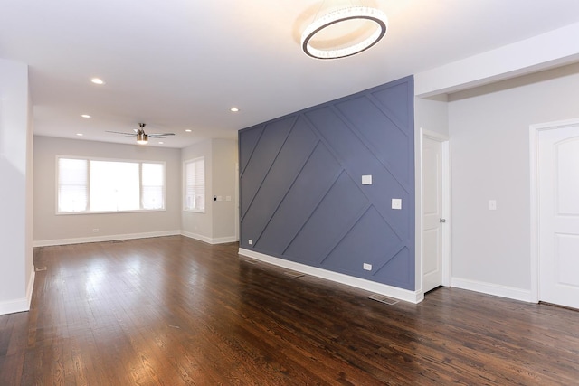 unfurnished living room with dark hardwood / wood-style floors and ceiling fan