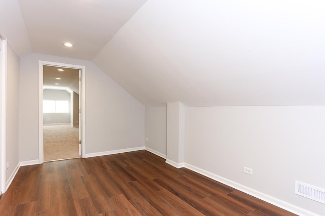 bonus room featuring dark hardwood / wood-style flooring and vaulted ceiling