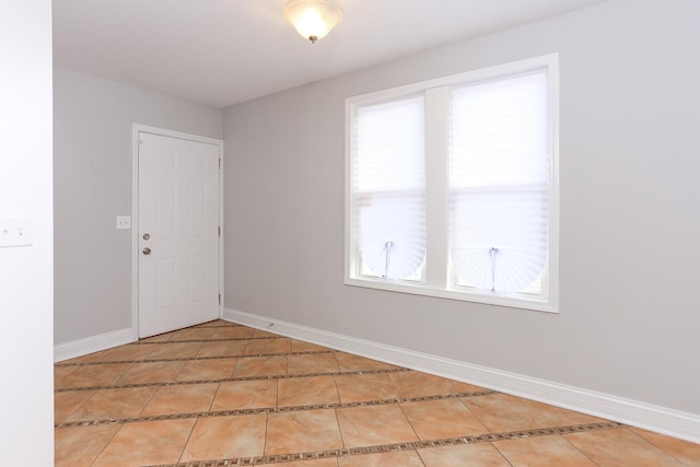 unfurnished room featuring tile patterned floors