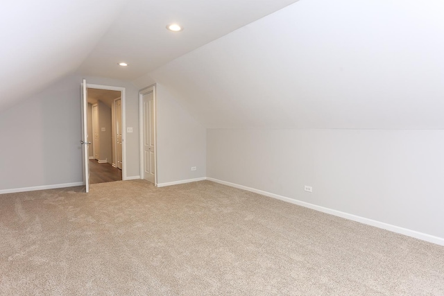 additional living space with vaulted ceiling and carpet floors