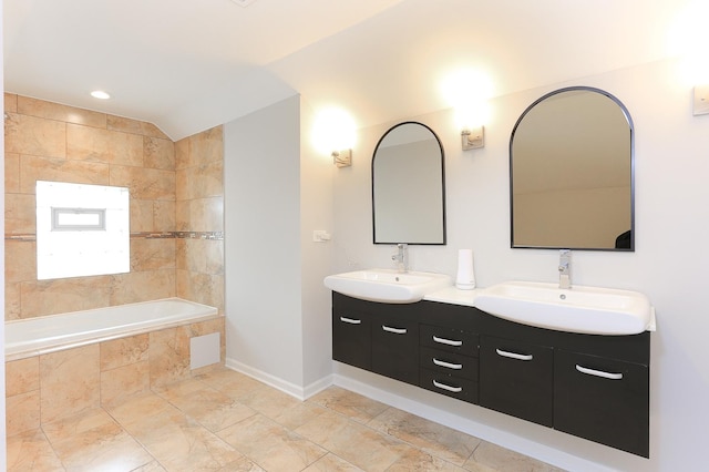 bathroom featuring vanity and vaulted ceiling