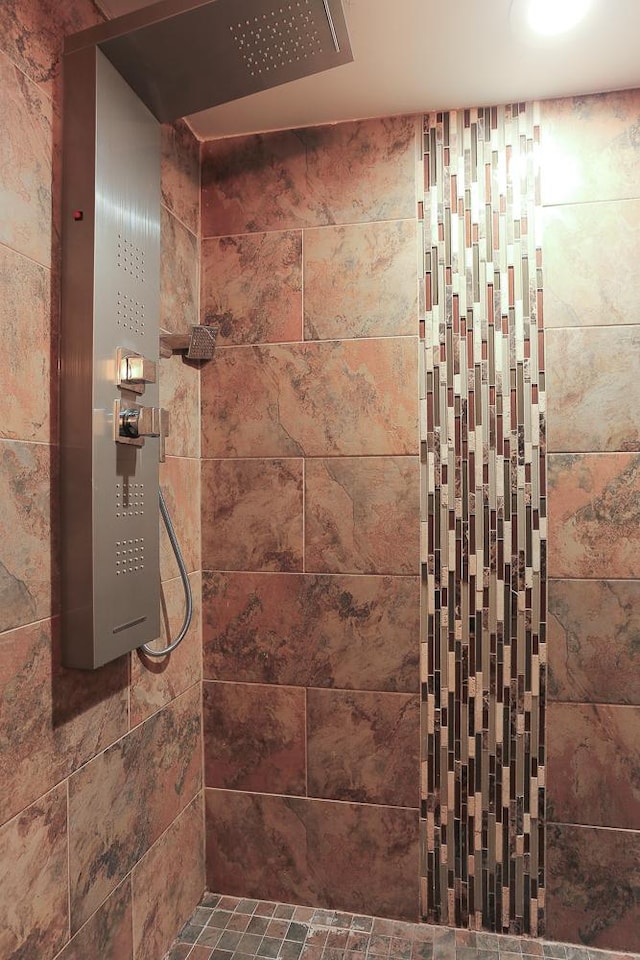 bathroom with tiled shower