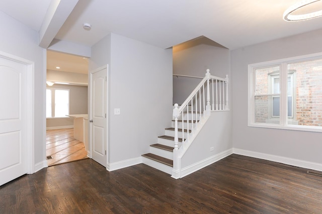 stairway with hardwood / wood-style flooring