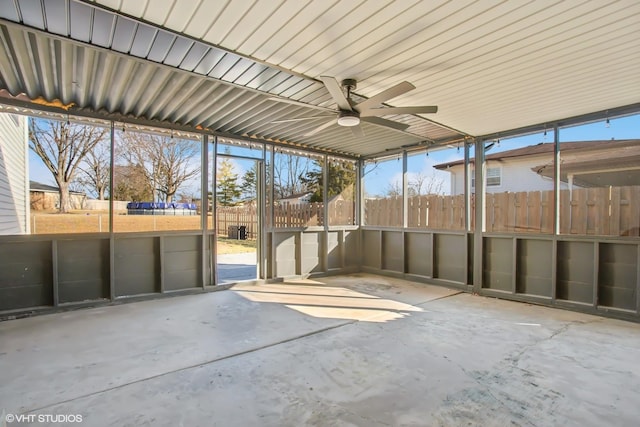 unfurnished sunroom featuring ceiling fan